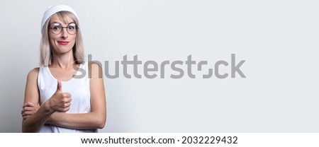 Surprised girl showing thumb up gesture class on light background. Banner.
