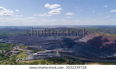 Open Iron Ore Quarry in industrial city Aerial Top View