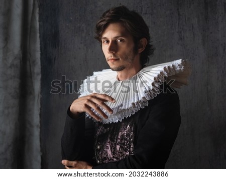 A noble young man in an old suit with a round Spanish collar, a portrait in the style of Renaissance paintings Royalty-Free Stock Photo #2032243886