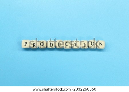 small wooden cubes with the word production