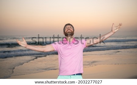 happy man over the sea feel freedom on morning summer beach, vacation