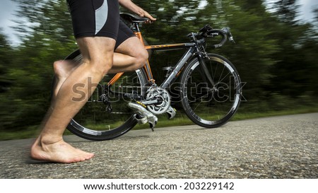 triathlete with a bicycle Royalty-Free Stock Photo #203229142