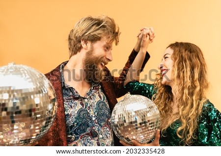 Happy young couple doing party and dancing in disco club