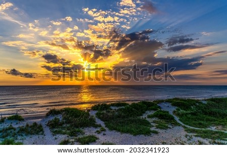 Sunrise on coastline beach in early morning Royalty-Free Stock Photo #2032341923