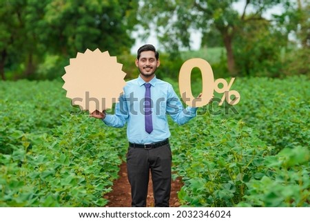 Young indian agronomist or financier showing zero percent sign or symbol at agriculture field