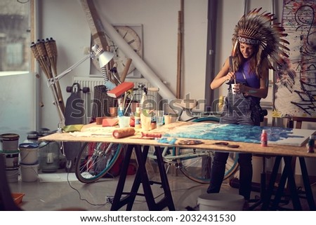 Caucasian female painter artist creating a piece in the studio; Creative lifestyle concept