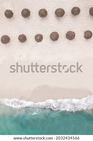Caribbean seaside and umbrellas. sand and the sea. drone upside down shot