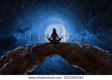 Woman meditating and observing the universe Royalty-Free Stock Photo #2032444265