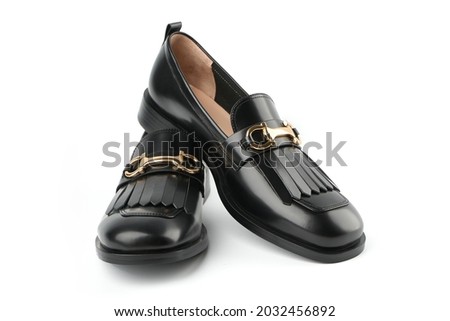 Loafers isolated on white background. Pair of Stylish Expensive Modern Leather Black Loafers Shoes. Fashion concept with woman shoes on white. Royalty-Free Stock Photo #2032456892