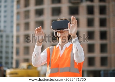 Futuristic Female Engineer Using Reality Headset At Building Construction Site.