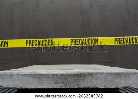 Caution tape in mexico on concrete back. Focus selection