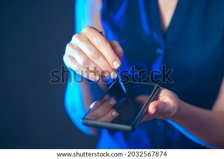 Female hands with smartphone and stylus. Businesswoman telephone. Businesswoman shows cellphone. Hands with selfie on dark background.  girl demonstrates switched off phone. Business apps concept