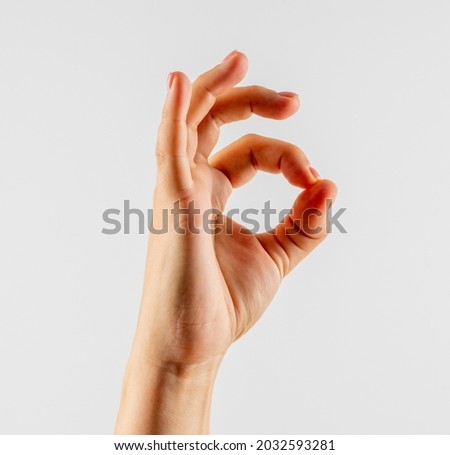 Womans hand ok sign on white background. Royalty-Free Stock Photo #2032593281