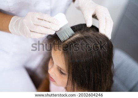 Child Doctor Checking Head Hair For Lice