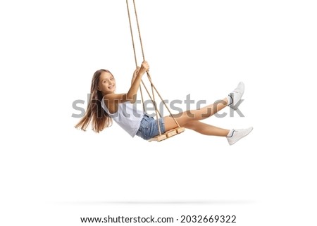 Beautiful girl with long hair swinging on a wooden swing isolated on white background Royalty-Free Stock Photo #2032669322