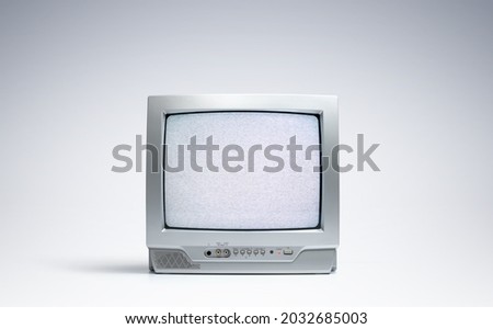 Working old CRT TV on the screen noise and interference on light background. File contains a path to isolation. Royalty-Free Stock Photo #2032685003