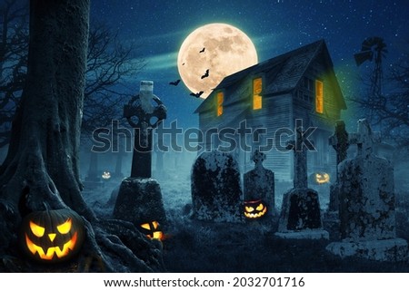 Abandoned scary house near the cemetery in the forest with pumpkins, a full moon, bats and fog. Pumpkins In Graveyard In The Spooky Night, Halloween Backdrop.