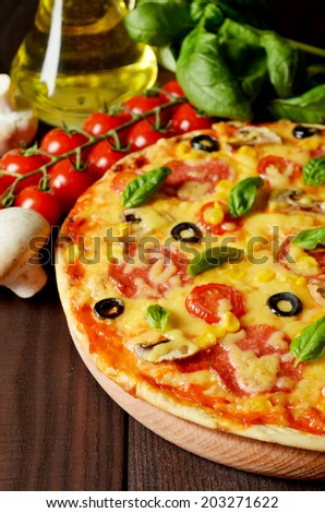 Pizza on brown wooden background
