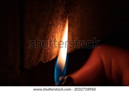 Fire from a lighter on a concrete background