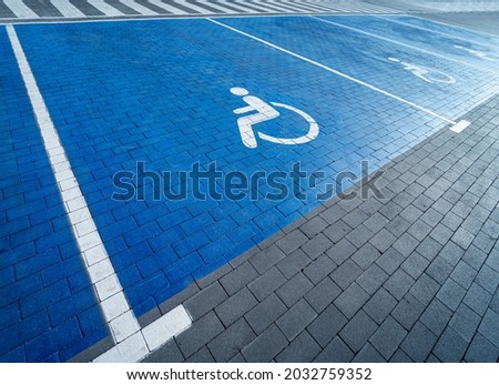 Handicapped symbol painted on a special parking space for disabled people