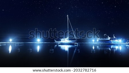 Blue sloop rigged yacht moored to a pier in marina at night. Clear twilight sky, stars, starlight, moonlight, lots of lights. Concept landscape. Copy space, graphic resources. Stockholm archipelago