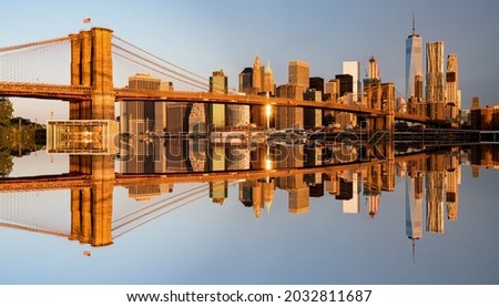 Brooklyn Bridge and skyline of New York City in the morning mirrored 