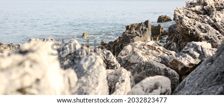 Stone in sea with wave on sunset time