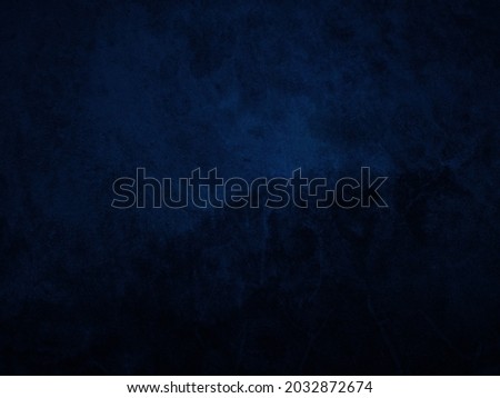 Dark rough cement wall background for graphic design or wallpaper. Grungy black and blue concrete texture in vintage style. The old plaster floor has a mysterious and terrifying age.