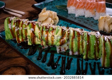 Set of sushi green dragon on a blue plate