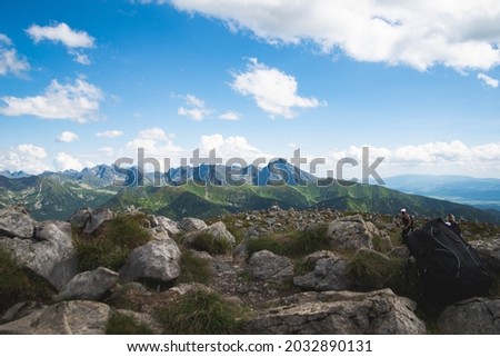 High Slovakian tatra peaks, mountains visible in the background, with unrecognized tourists on the front