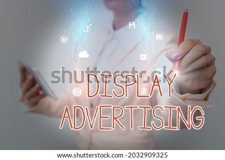 Conceptual caption Display Advertising. Business concept online advertising that is typically a designed image Business Woman Using Phone While Presenting New Futuristic Virtual Display.