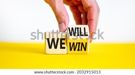 We will win symbol. Businessman turns a cube and changes words we will to we win. Beautiful white and yellow background, copy space. Business, motivational and we will win concept. Royalty-Free Stock Photo #2032915013