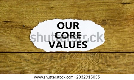 Our core values symbol. Words 'Our core values' on white paper. Beautiful wooden background. Business and our core values concept. Copy space.