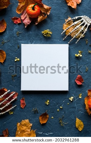 Halloween canvas mockup. Blank white canvas frame and Halloween decorations. Top view.