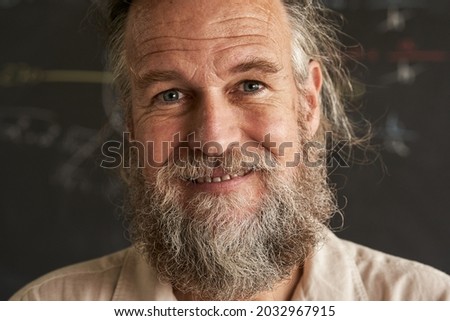Portrait of an older man with beard and gray hair. The man has a friendly and sincere smile. Royalty-Free Stock Photo #2032967915