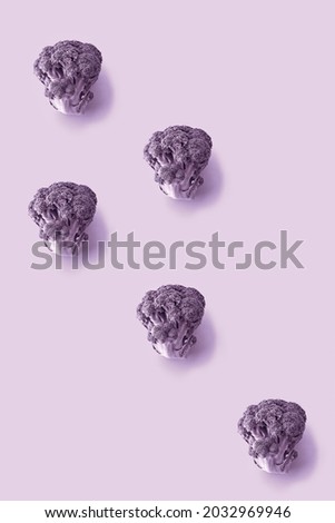 Fresh toned broccoli pattern on color paper background.  Abstract creative food concept, flat lay