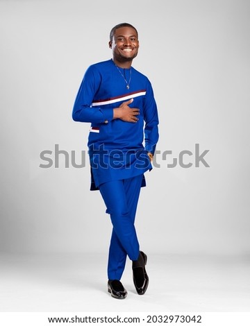 portrait of a young african man dressed in stylish native attire smiling Royalty-Free Stock Photo #2032973042