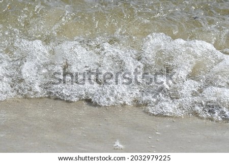 Photo of a wave coming in on the beach or shore