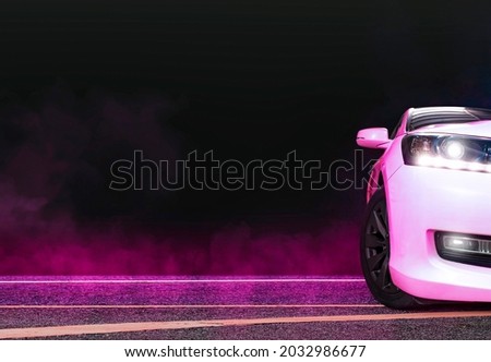 Sedan car and pink smoke on the asphalt road at night,copy space Royalty-Free Stock Photo #2032986677
