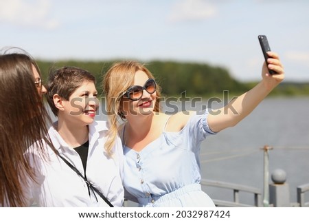 Women on the river are photographed on the phone