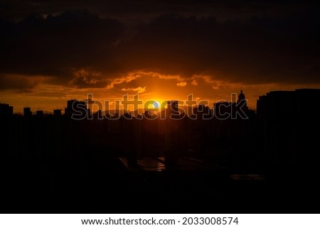 beautiful color image of the sunset with silhouettes of buildings in the center of the city of são paulo