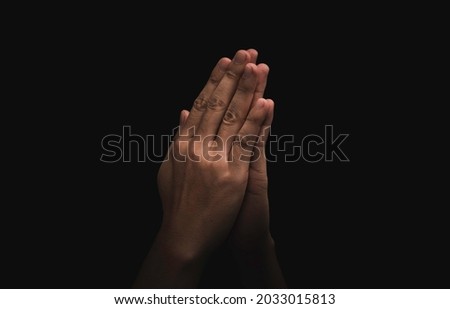 Two hand praying pay respect on dark background , this action for Thailand culture concept. Royalty-Free Stock Photo #2033015813