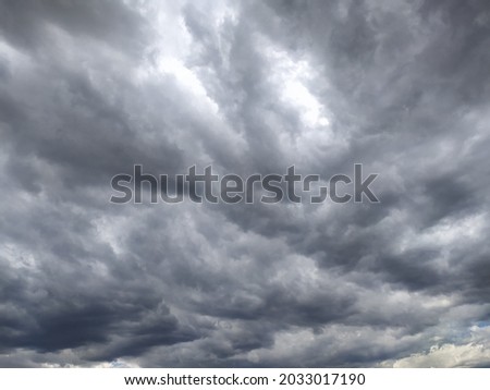 Storm clouds timelapse, background. Sky with gray clouds, storm, background, thunderclouds, unstable changeable weather Royalty-Free Stock Photo #2033017190