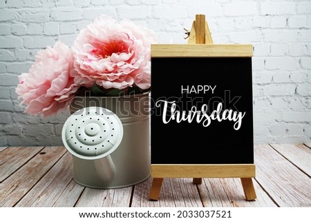 Happy Thursday typography text on easel wooden board Royalty-Free Stock Photo #2033037521