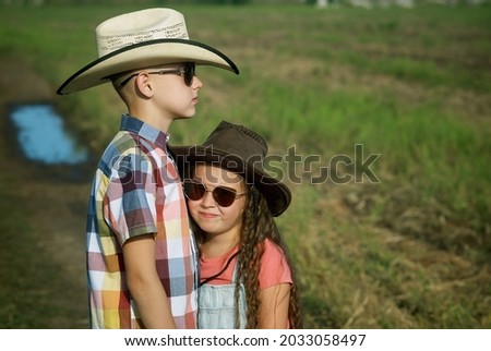 portrait of children in cowboy hats in nature