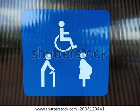 Signage for the disabled, the elderly, the pregnant.  Blue banners showing assistance to the elderly, disabled, and pregnant women. Thailand.