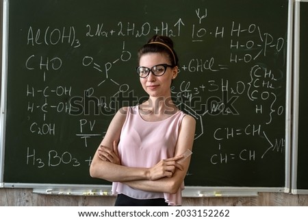 teacher of chemistry against blackboard explane chemical formula, education concept