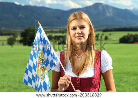 bavarian girl in front of a meadow