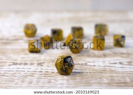 Set of dice for fantasy dnd and rpg tabletop games. Board game polyhedral dices with different sides on light wooden background