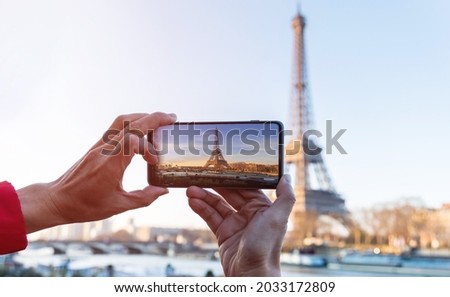  Selective focus of man hand with he is using smartphone take photo at View on Eiffel Tower, Paris, France